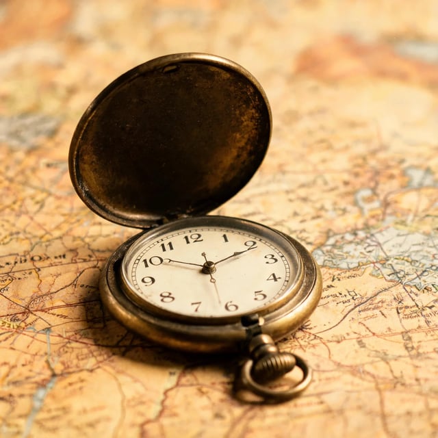 Open brass pocket watch with a cream dial and black numerals lying on an old map in soft daylight, by Seedream 5 Lite at 3K
